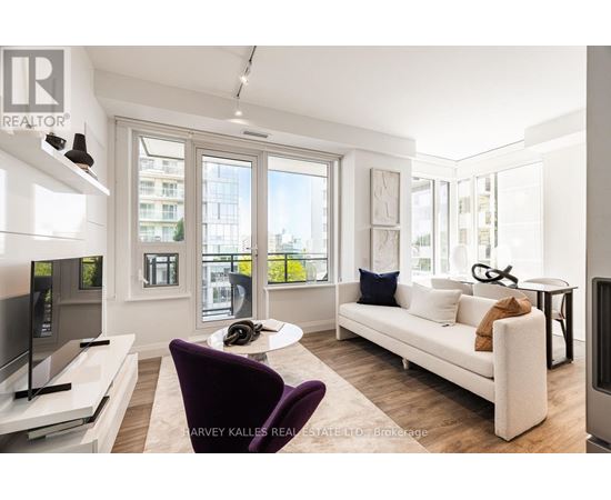 A living room with a purple chair and a white couch.