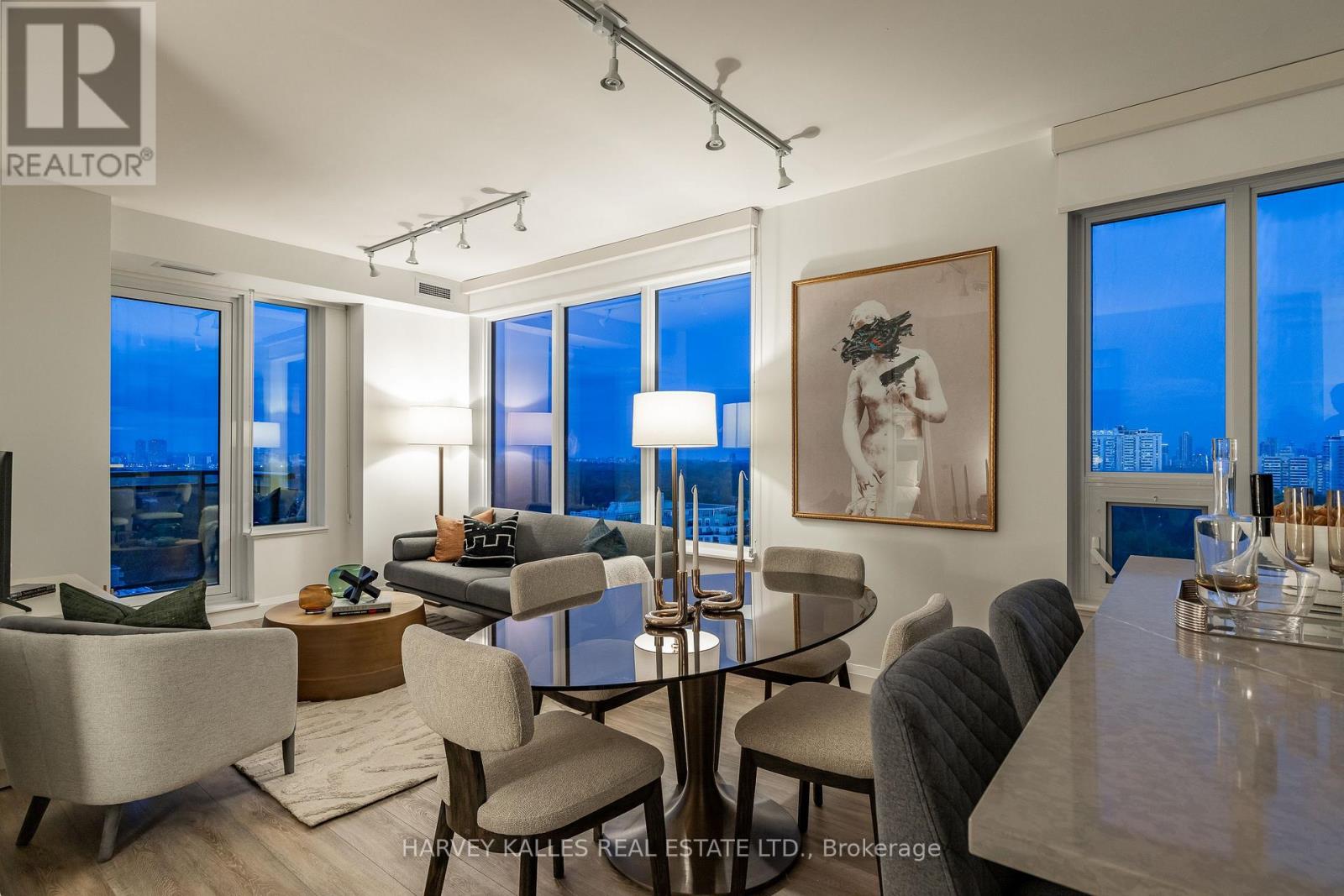 A well-lit living room with a dining table and chairs.