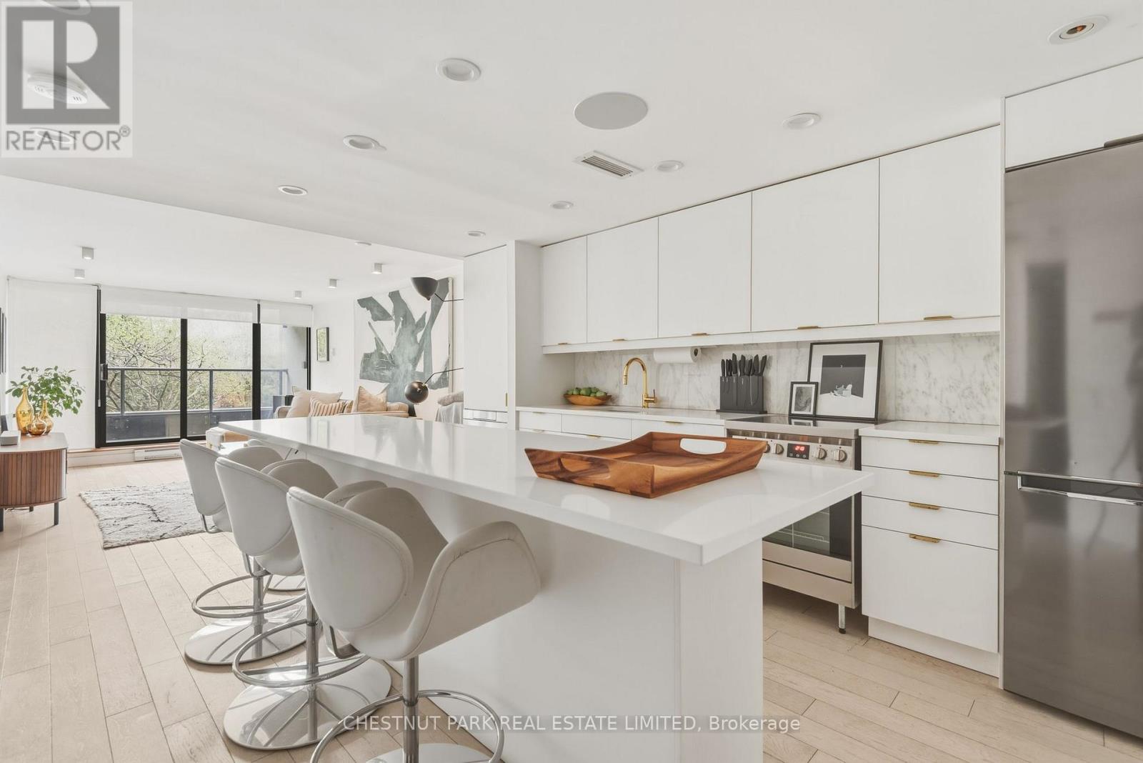 A modern kitchen with white cabinets and a large island.