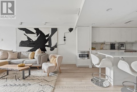 A modern living room with a large abstract painting on the wall.