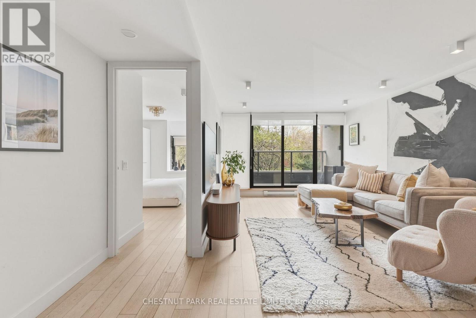 A modern living room with a large window and a view of the outdoors.