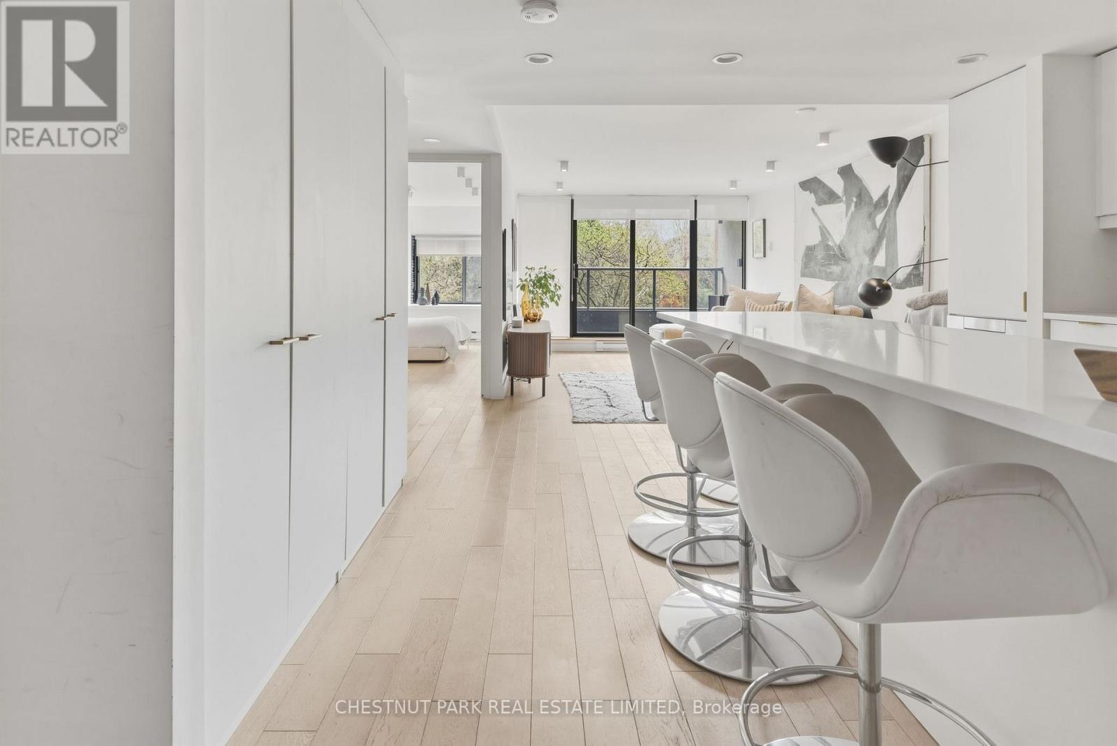A realtor logo is on the wall in a modern kitchen.