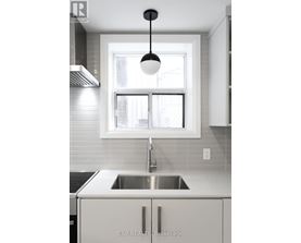 A modern kitchen with EXP Realty Brokerage written on the sink.