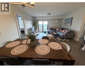 A dining room with a wooden table and chairs.