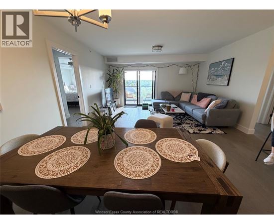 A dining room with a wooden table and chairs.