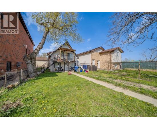 A realtor photo of a house with a yard.