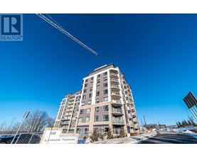 A tall residential building with a crane in the background.