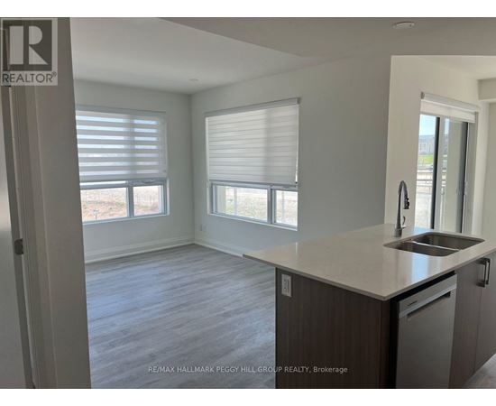 A kitchen with a sink and a window with blinds.