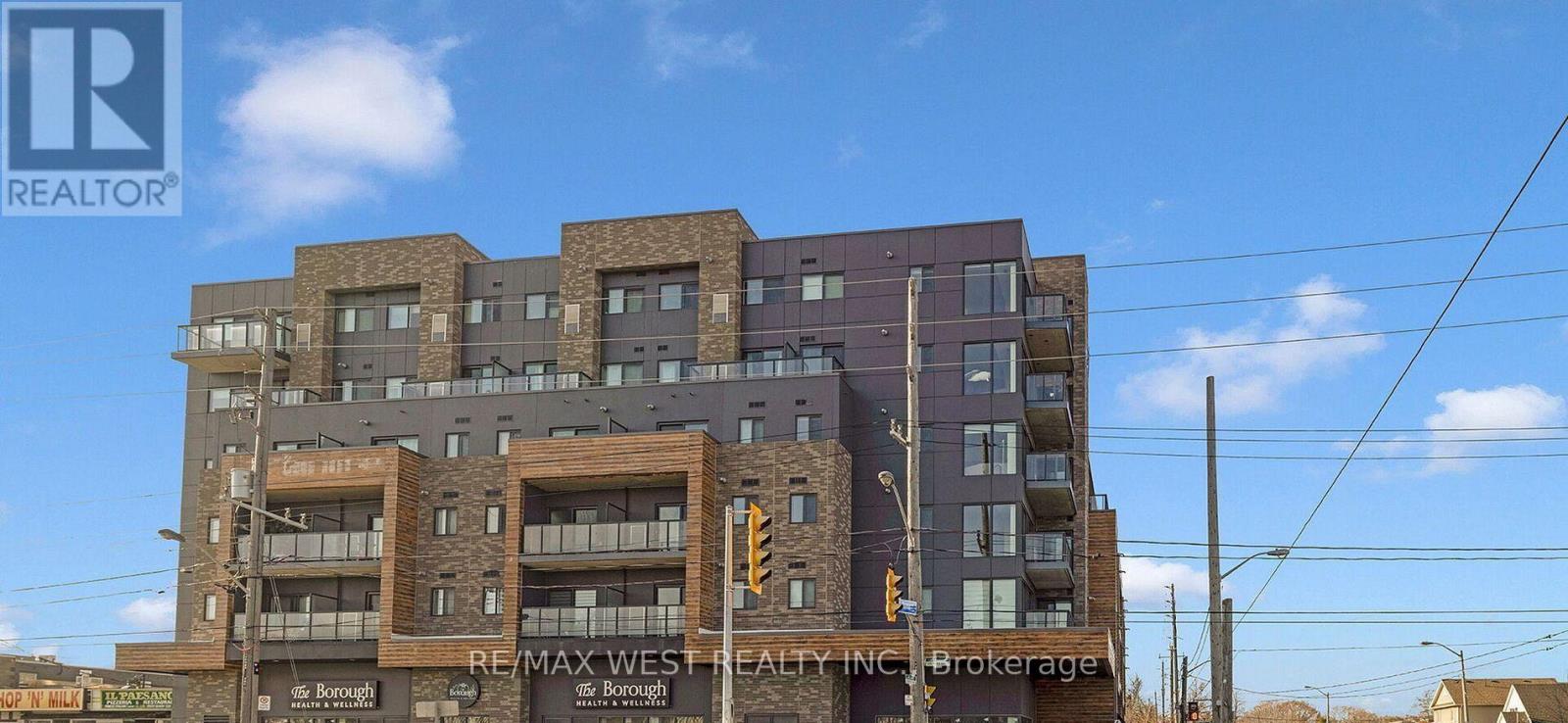 A multi-story building with a sign that reads "RE/MAX West Realty Brokerage.".