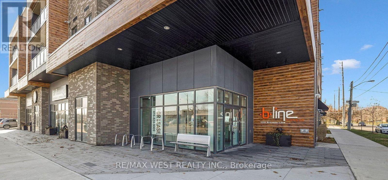 A modern building with a glass entrance and a wooden exterior.