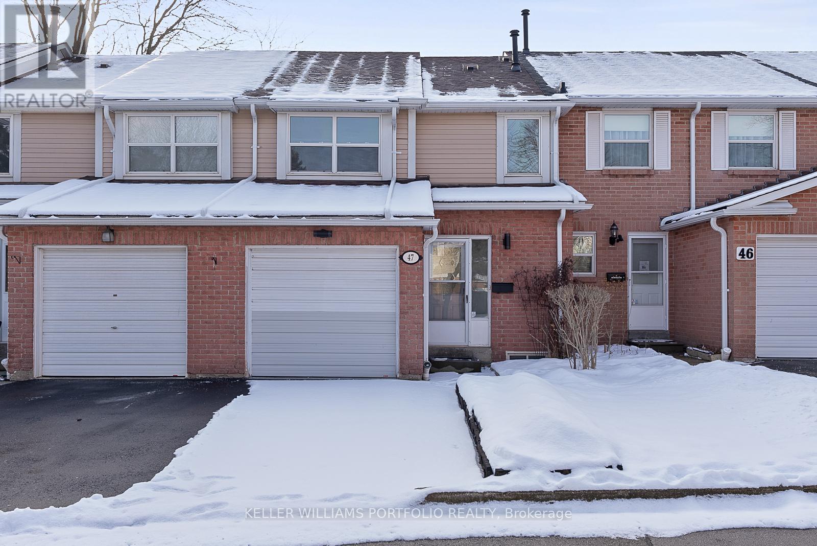 A house with a snow-covered front yard.