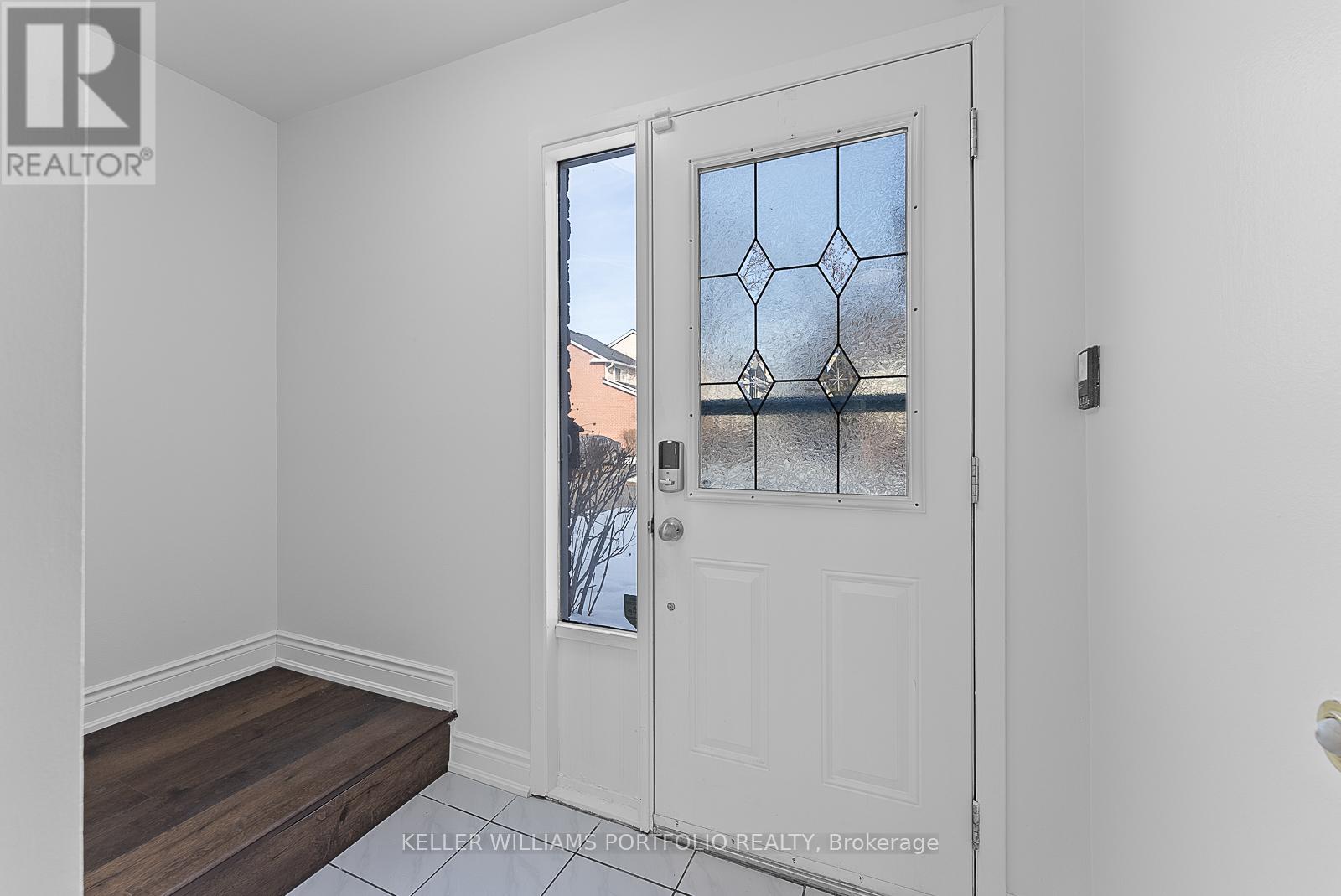 A white door with a glass window and a handle.