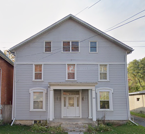A two-story house with a front porch.