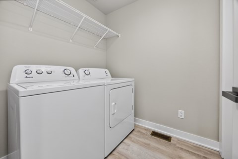 A white washing machine and dryer in a small laundry room.