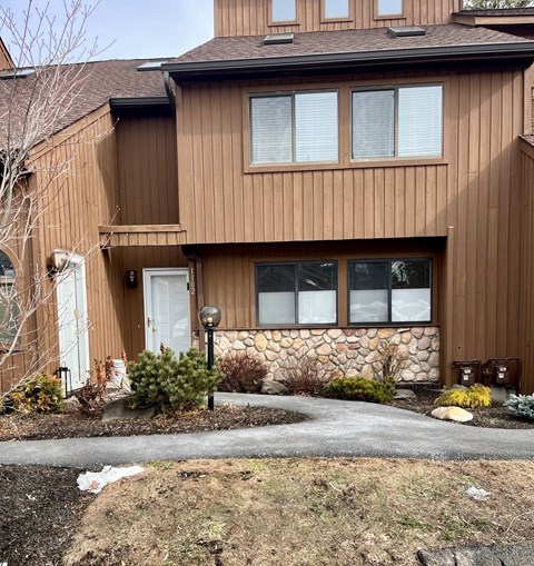 A brown house with a white door and windows.