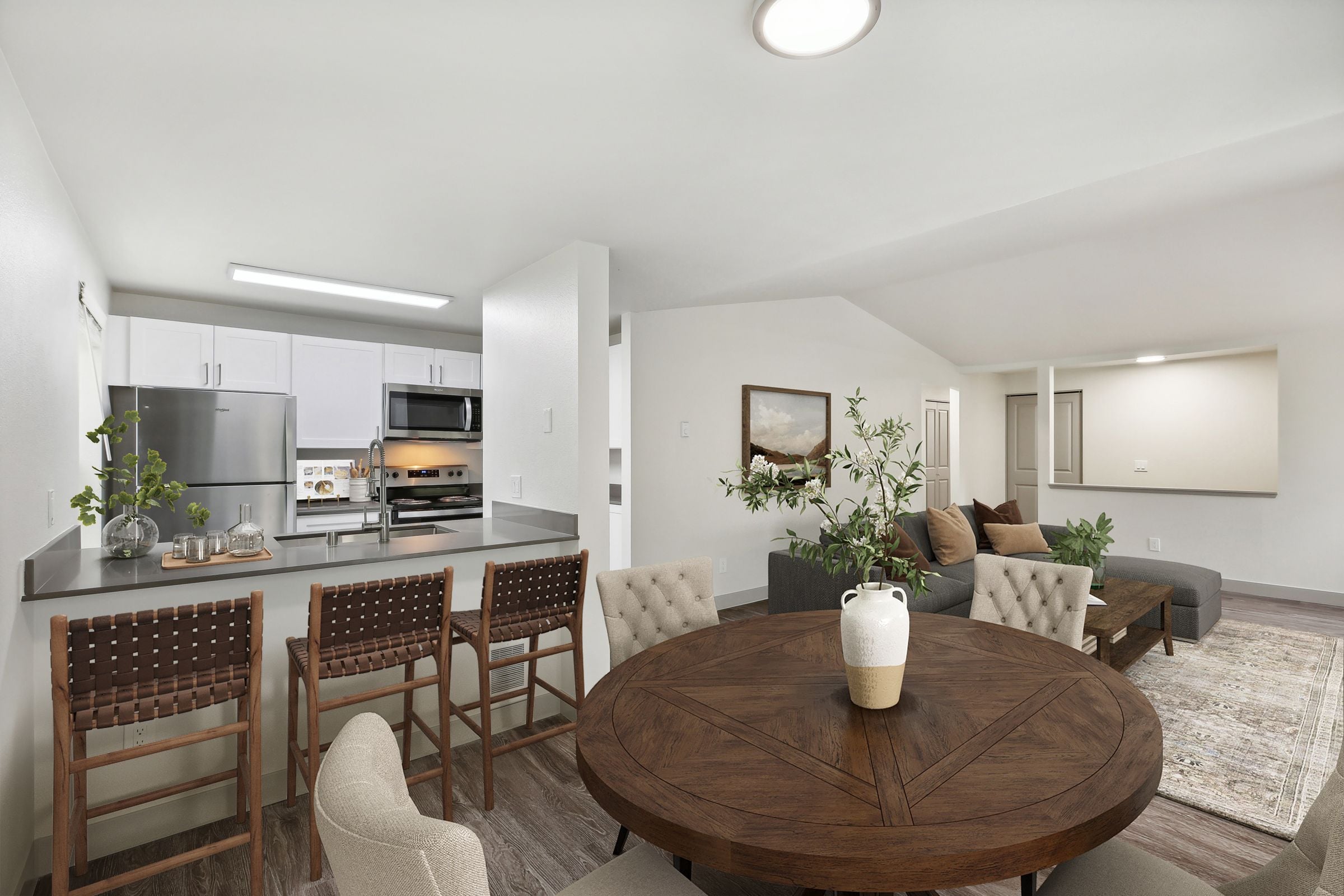 A modern kitchen with a dining table and chairs.