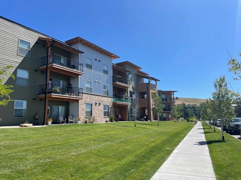 Apartment complex with a walkway in front.
