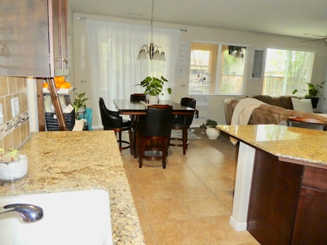 A kitchen with a table and chairs in the middle of the room.