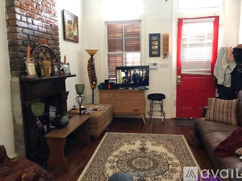 A living room with a fireplace and a couch.
