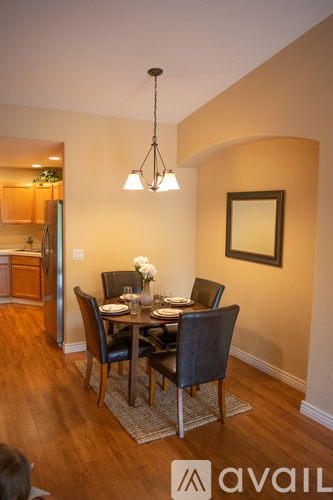 A dining room with a table set for four.
