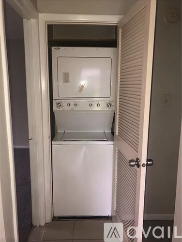A white oven and microwave are in a small kitchen.