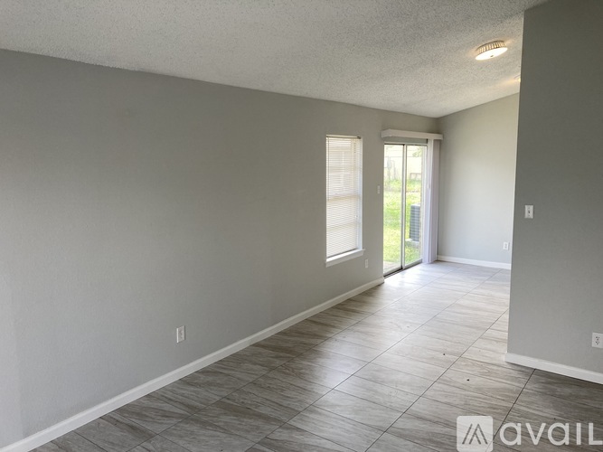A room with a tiled floor and a sliding glass door.