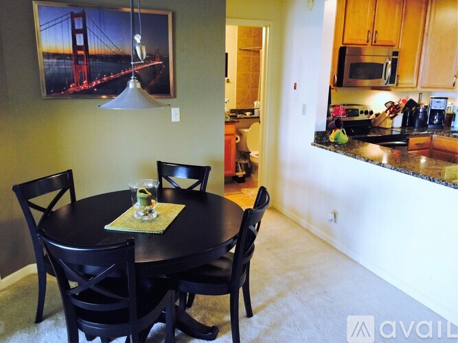 A dining room with a table set for two and a view of the Golden Gate Bridge.