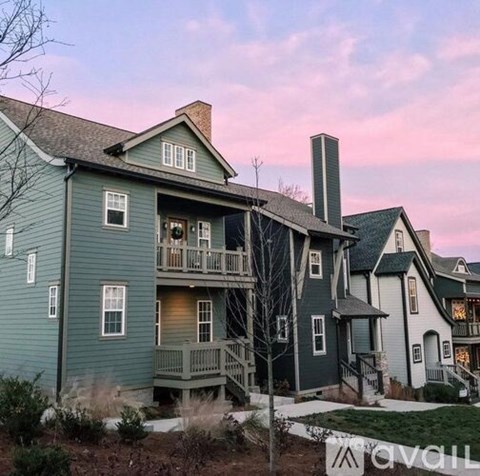 A row of houses with a sign that says "available" in front of them.