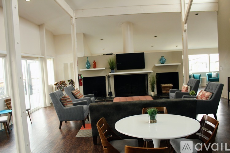 A living room with a fireplace and a television.
