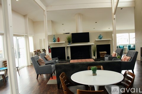 A living room with a fireplace and a television.