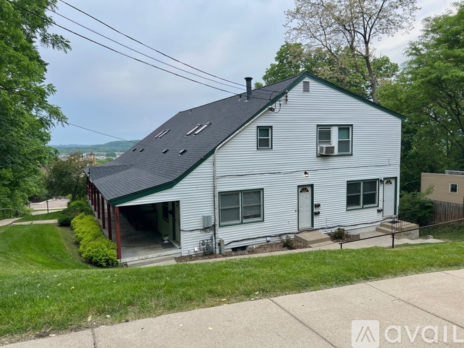 A two-story house with a garage is for sale.