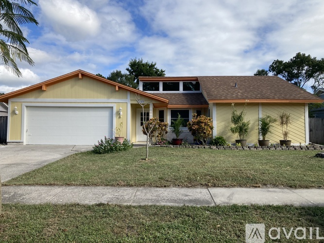 A house with a garage door and a driveway.