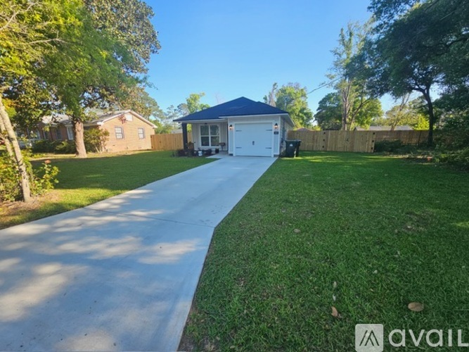 A house with a driveway leading to a garage.