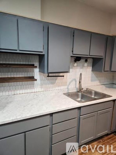 A kitchen with a sink and cabinets.