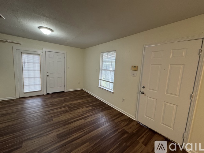 A room with wooden floors and white walls.
