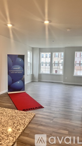 A room with a red carpet and a banner on the wall.