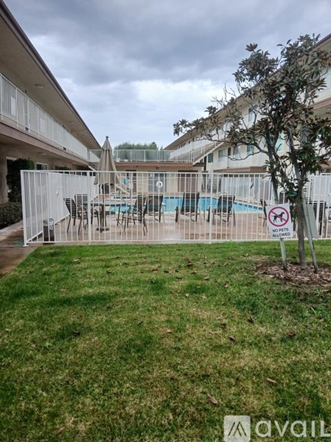 A pool area with a no swimming sign in the foreground.