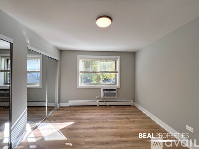 A room with a window and a wooden floor is on the market.