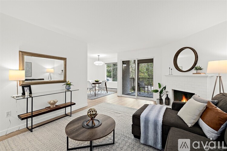 A living room with a fireplace, a mirror, and a couch.