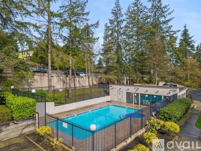 A house with a pool surrounded by a fence.