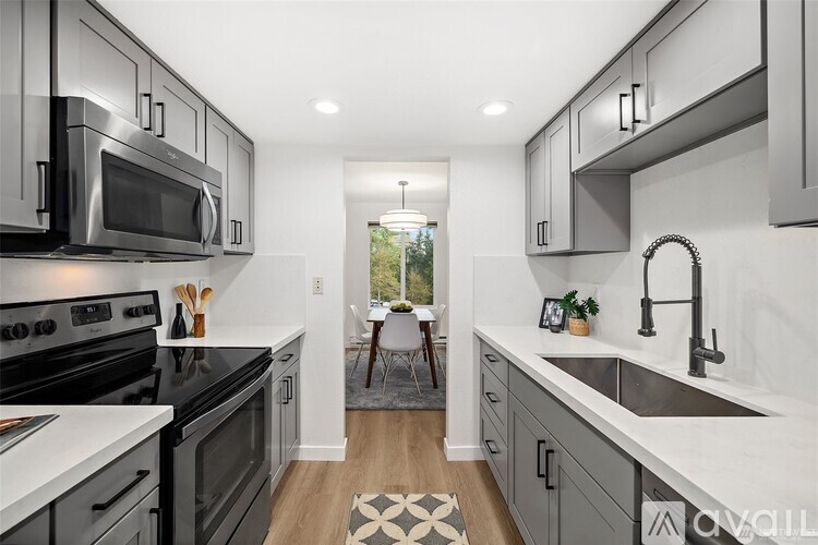 A modern kitchen with a black stove top oven and a black microwave above it.