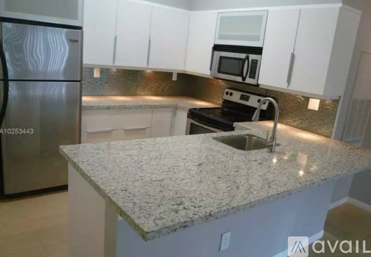 A kitchen with granite countertops and stainless steel appliances.