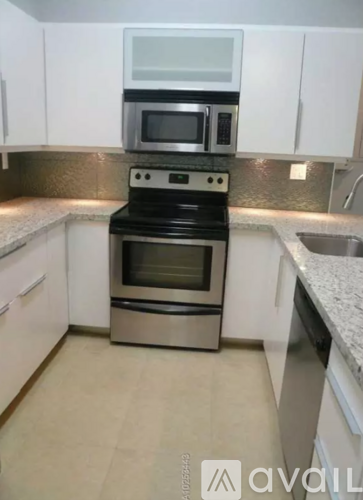 A kitchen with a stove top oven and microwave above it.
