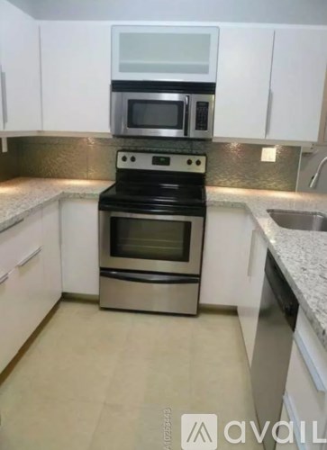 A kitchen with a stove top oven and microwave above it.