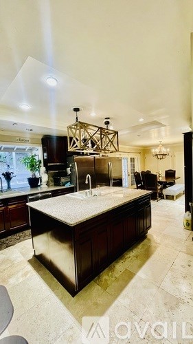 A kitchen with a large island in the middle.