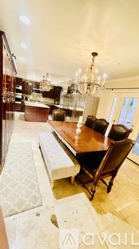 A dining room with a wooden table and chairs.