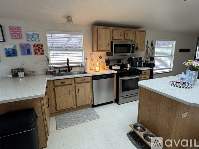 A kitchen with wooden cabinets and a white countertop.