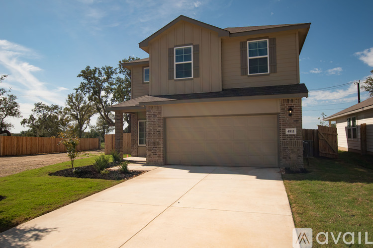A two-story house with a garage is available for sale.