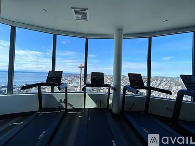 A treadmill room with a view of the city.