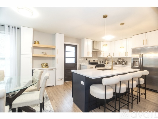A modern kitchen with white cabinets and a central island.